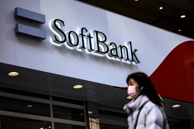 (FILES) In this file photo taken on February 8, 2021, a pedestrian walks past the logo for telecom and investment giant SoftBank Group along a street in Tokyo. - Japanese investment giant SoftBank Group will buy a 40 percent stake in Norwegian robotics company AutoStore in a deal worth 2.8 billion USD, the two firms said on April 5, 2021. (Photo by Charly TRIBALLEAU / AFP)