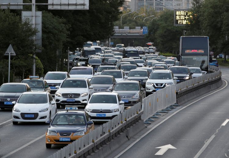 FILE PHOTO: Cars drive on the road during the evening rush hour in Beijing, China, July 1, 2019. Picture taken July 1, 2019. REUTERS/Jason Lee/File Photo
