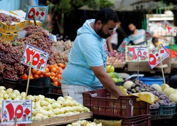 A vendor waits for customers at a market in Abbdien square in Cairo, Egypt