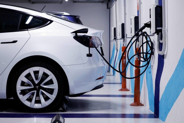 FILE PHOTO: An electric vehicle is plugged into a charging station in Bilbao, Spain, February 15, 2023. REUTERS/Vincent West